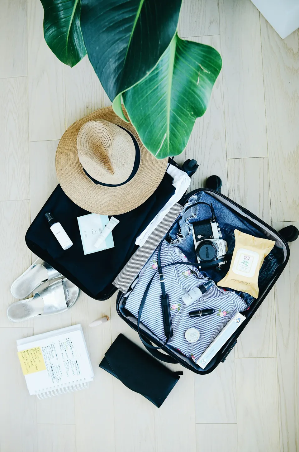 Open suitcase with travel essentials