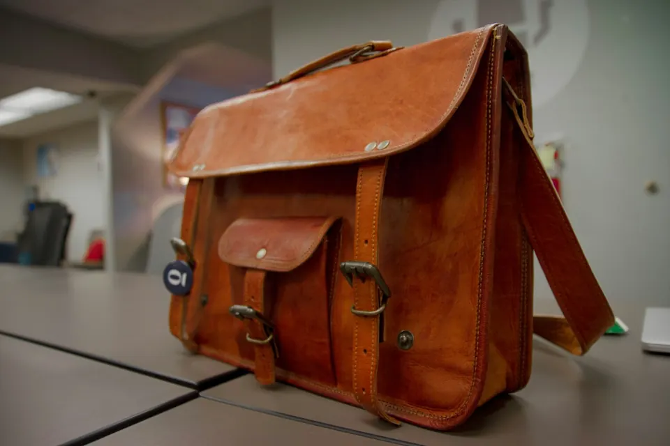 Closeup photo of brown leather crossbody bag