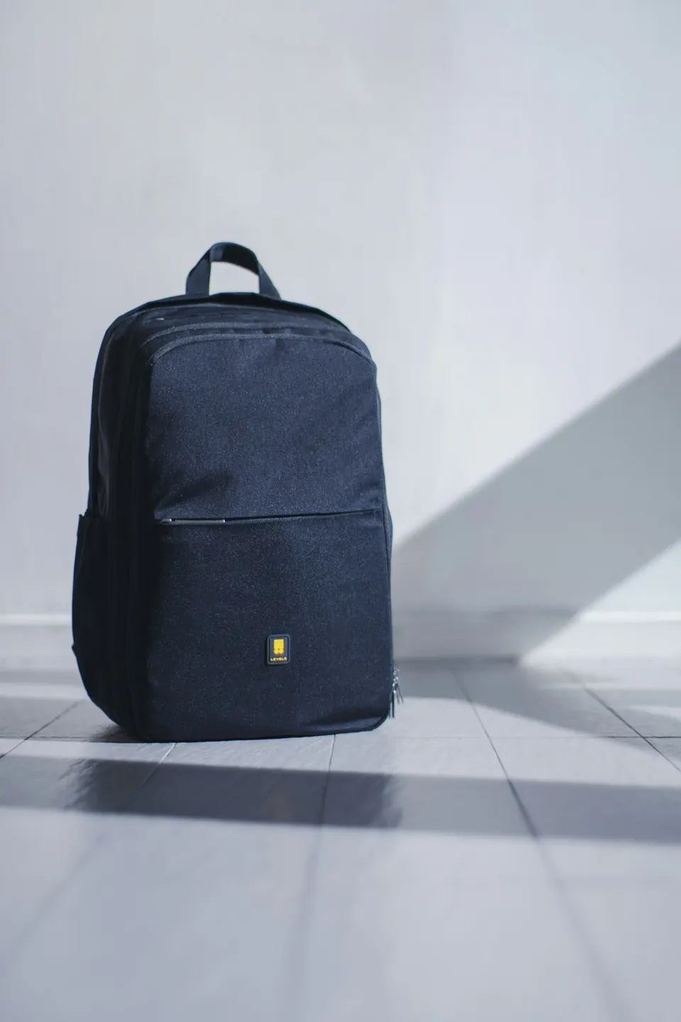 A black backpack on a white floor