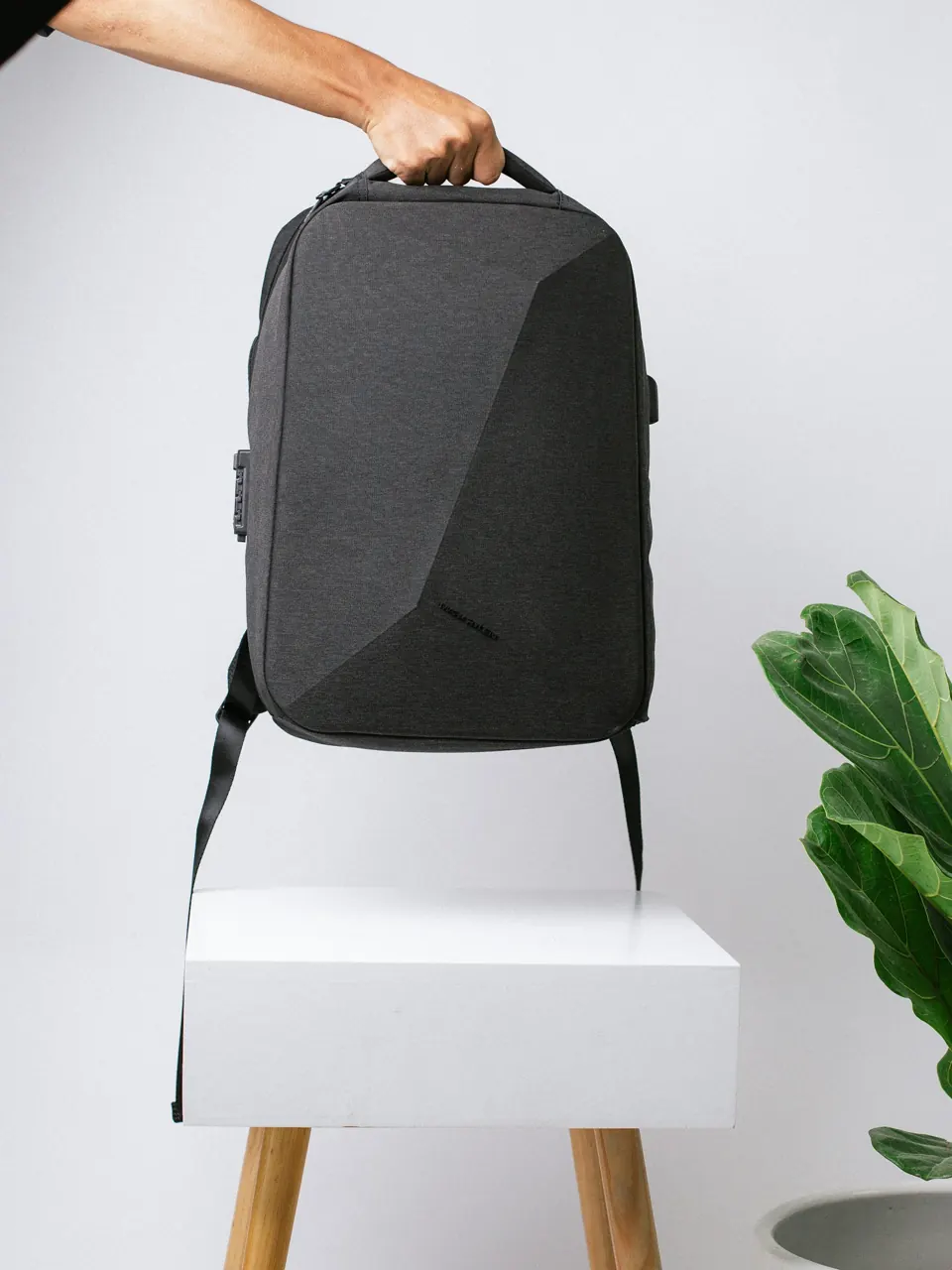 Black backpack on white box