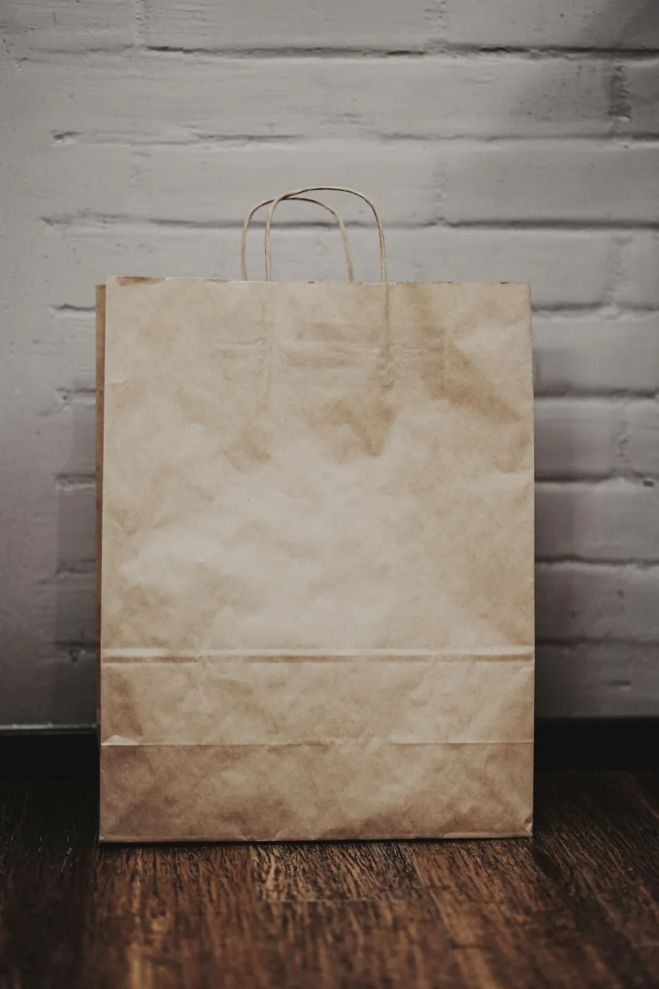 Brown paper bag on white textile