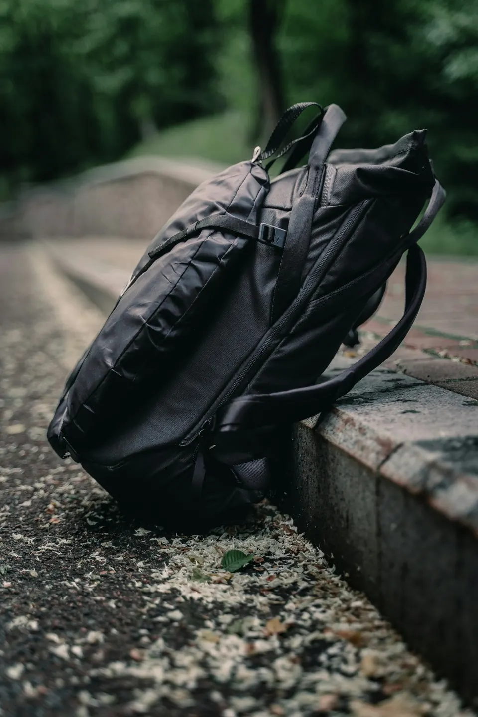 Black leather backpack on a bench