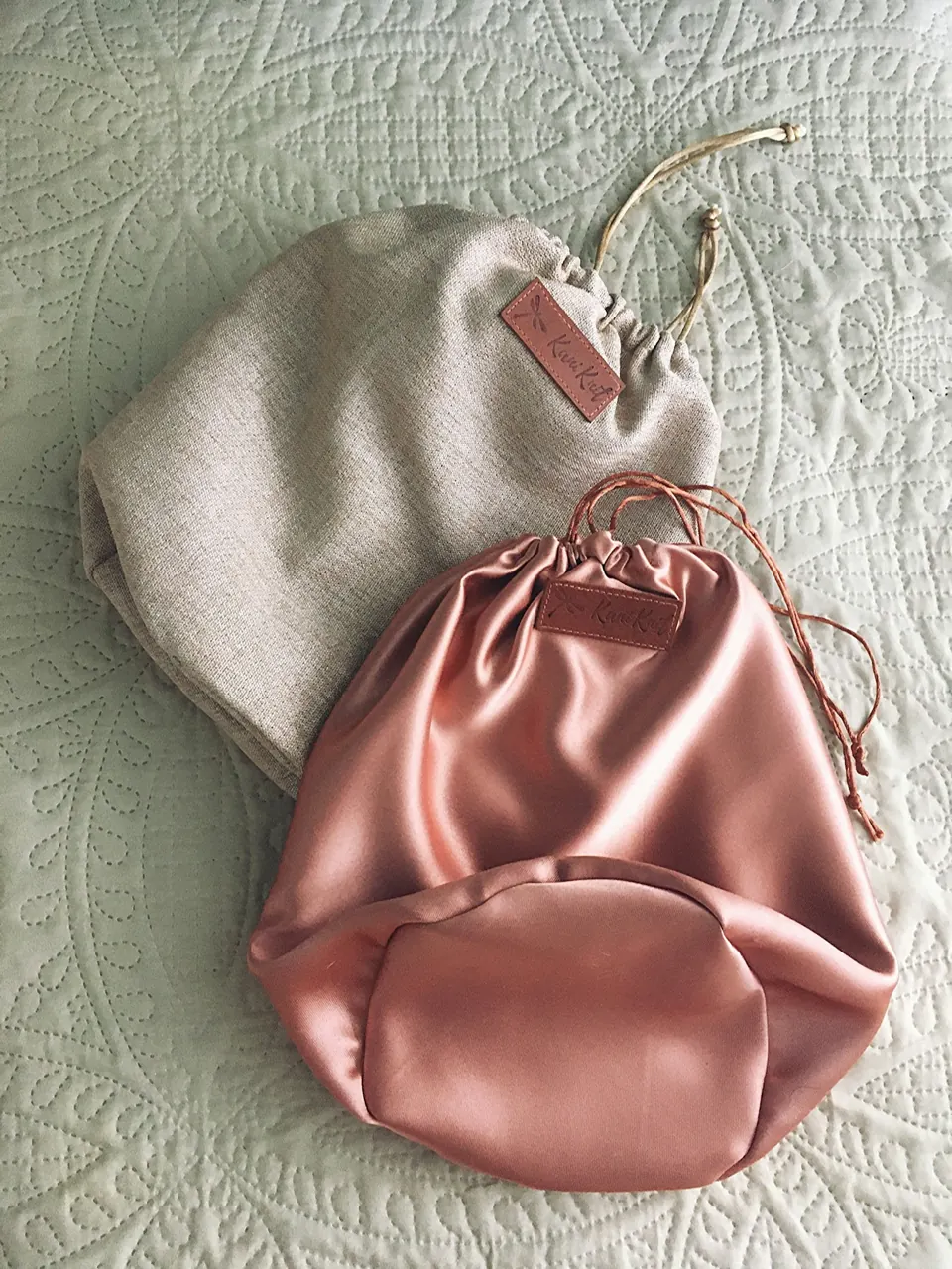 Pink leather bag on white textile