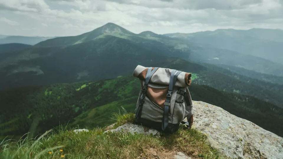 Black and gray hiking backpack on grass