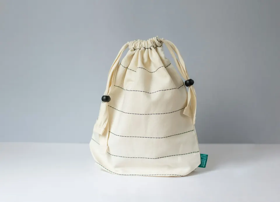 A white bag sitting on top of a white table