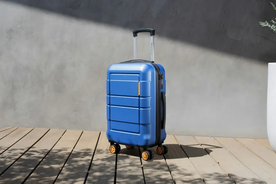 A blue suitcase on a wooden floor