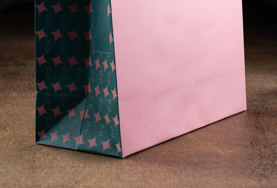 A pink and green gift bag with stars