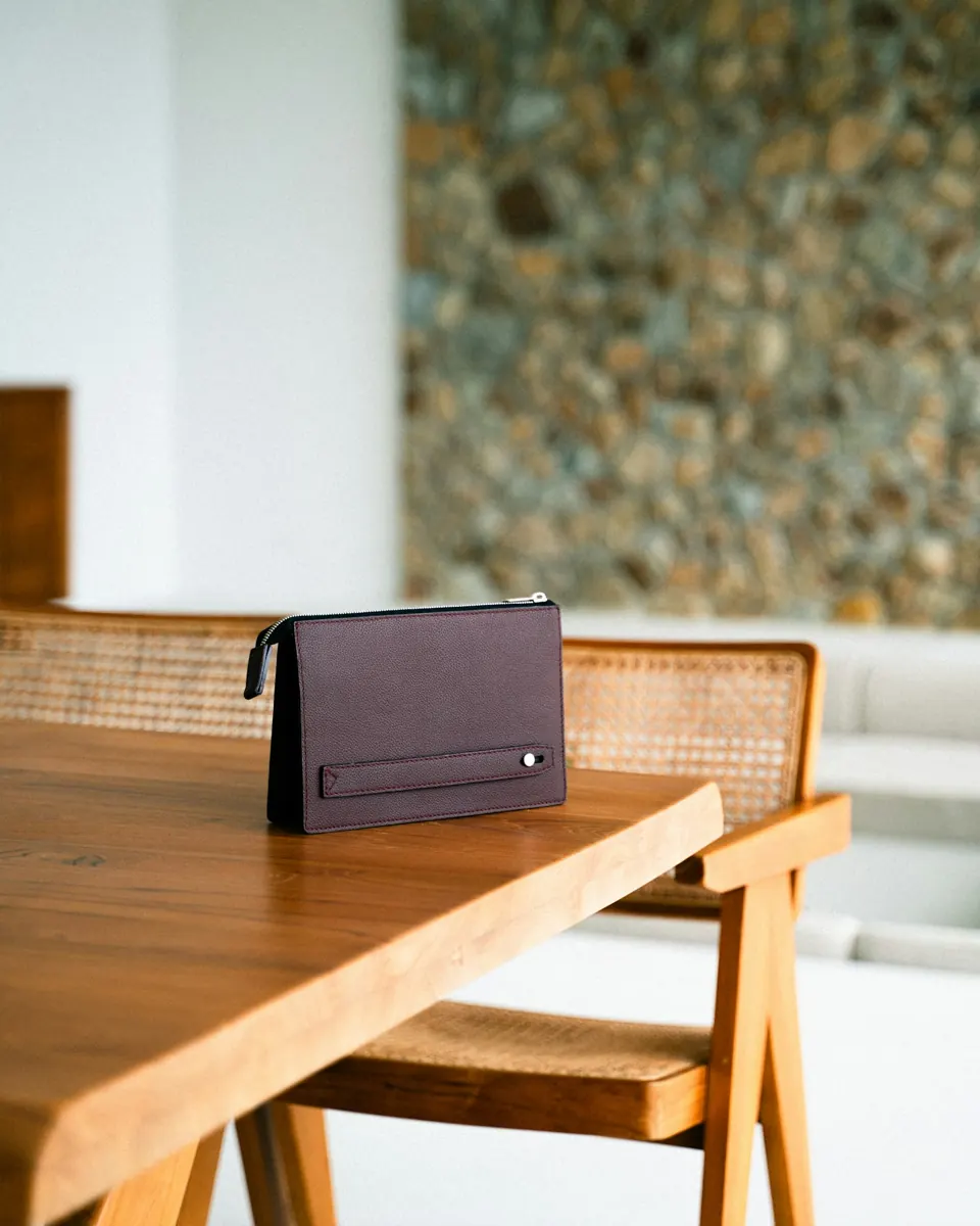 A brown clutch on a wooden table