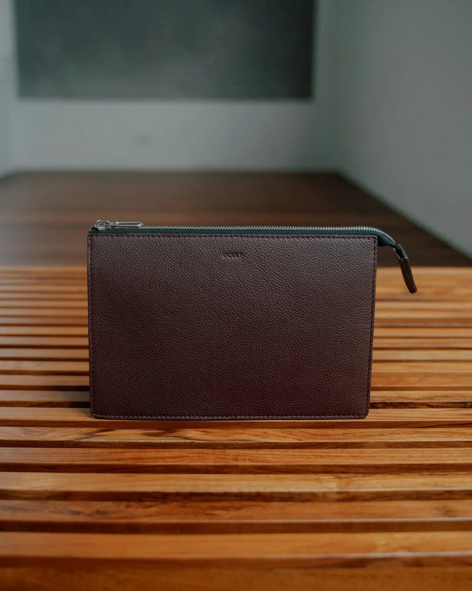 A brown clutch on a wooden table