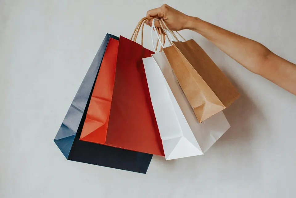 Hand holding colorful shopping bags