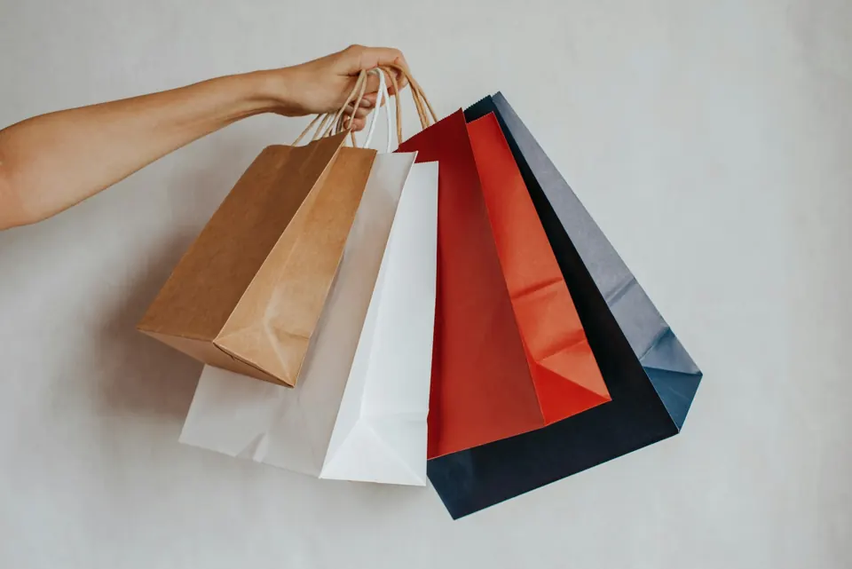Hand holding colorful shopping bags